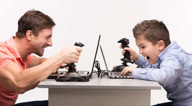 Father and son playing the computer games