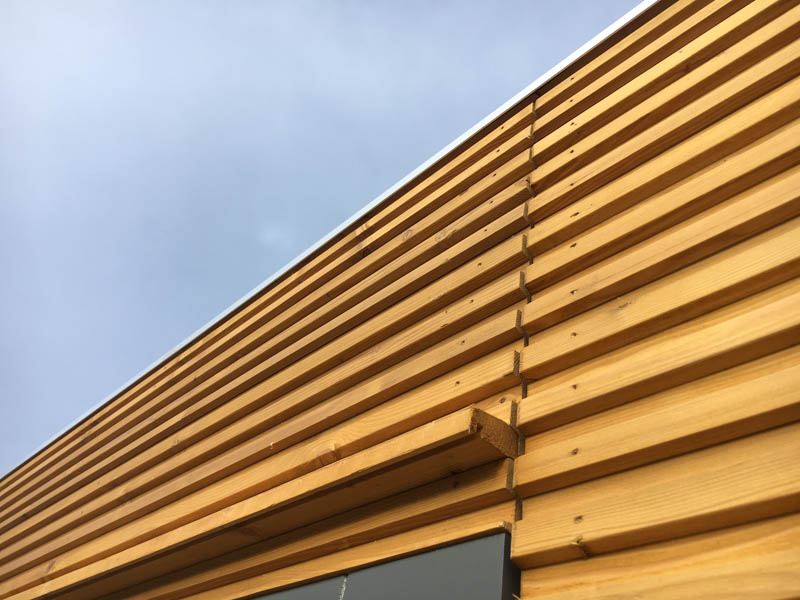 The Larch cladding is fitted in a batten & board patten