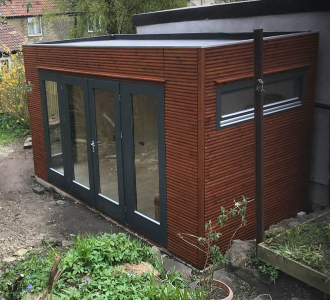 A garden room that can be positioned tight to a fence