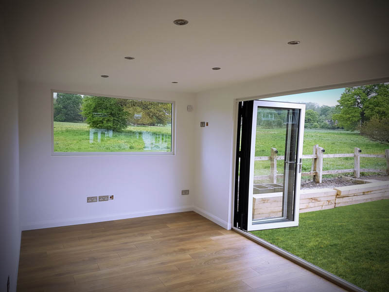 Incorporating two sets of doors floods this garden room with light