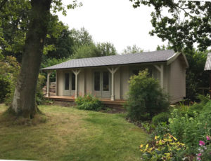 Log cabin garden room with veranda