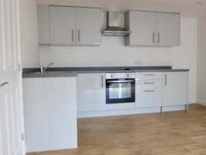 The garden annexe has a well equipped kitchen with high gloss units
