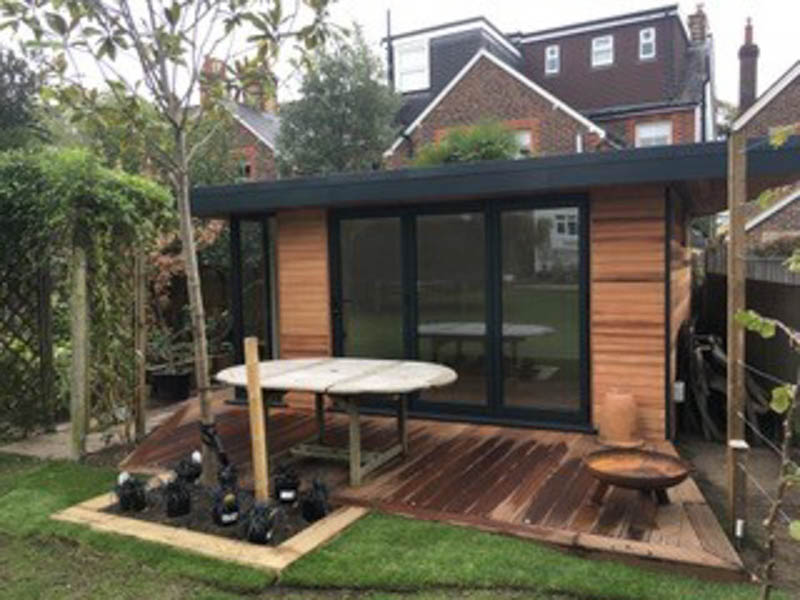 This garden office has been shaped so that it follows the line of the fence