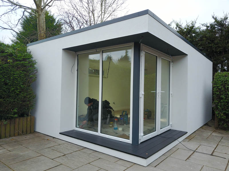 White renders mixed with grey trims create a striking garden room