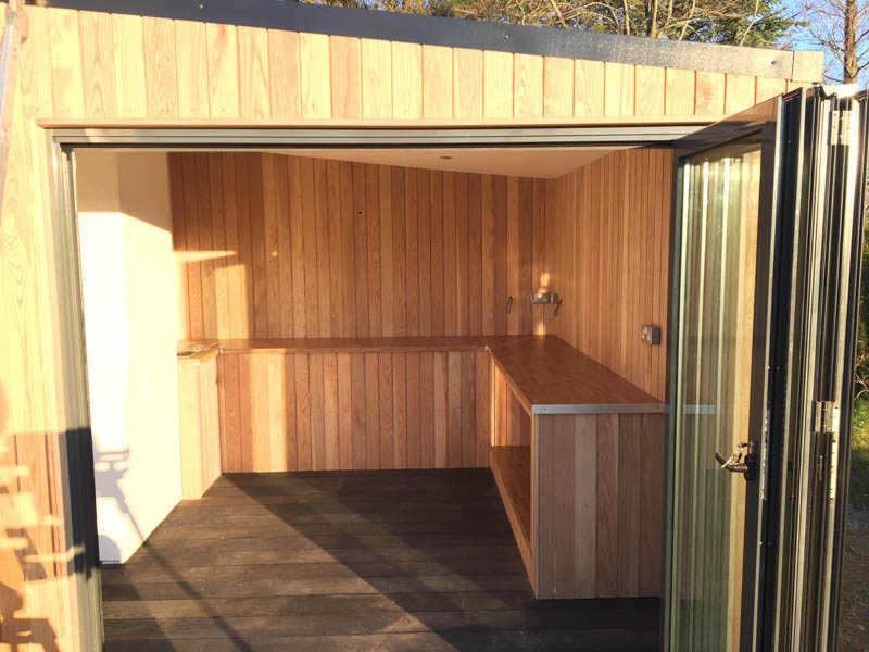 Bespoke Oak cabinets have been fitted in the outdoor kitchen