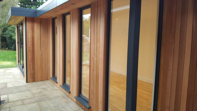 Long windows have been spaced with cedar clad walls