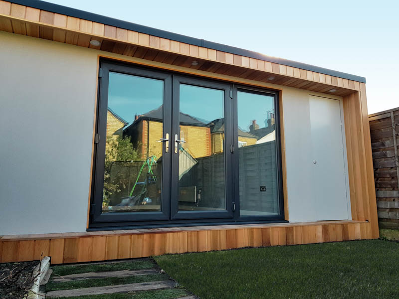 The grey render contrasts well with the Cedar cladding