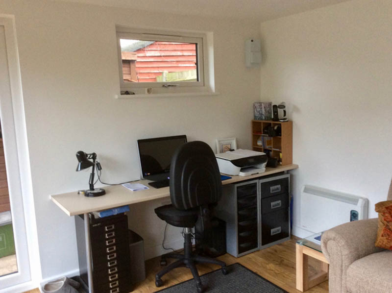 A small window has been positioned high above the desk