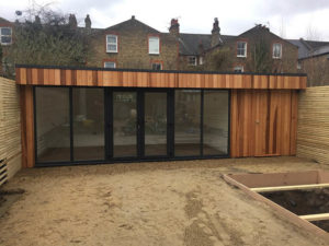 The garden room slots in tight to three boundary fences