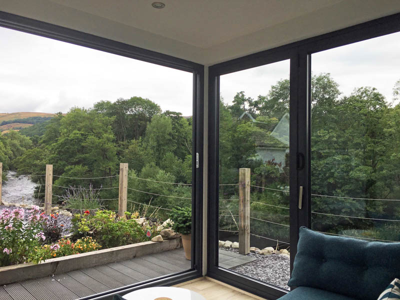 A large set of sliding doors has been combined with a set of bi-fold doors to create a glazed corner.