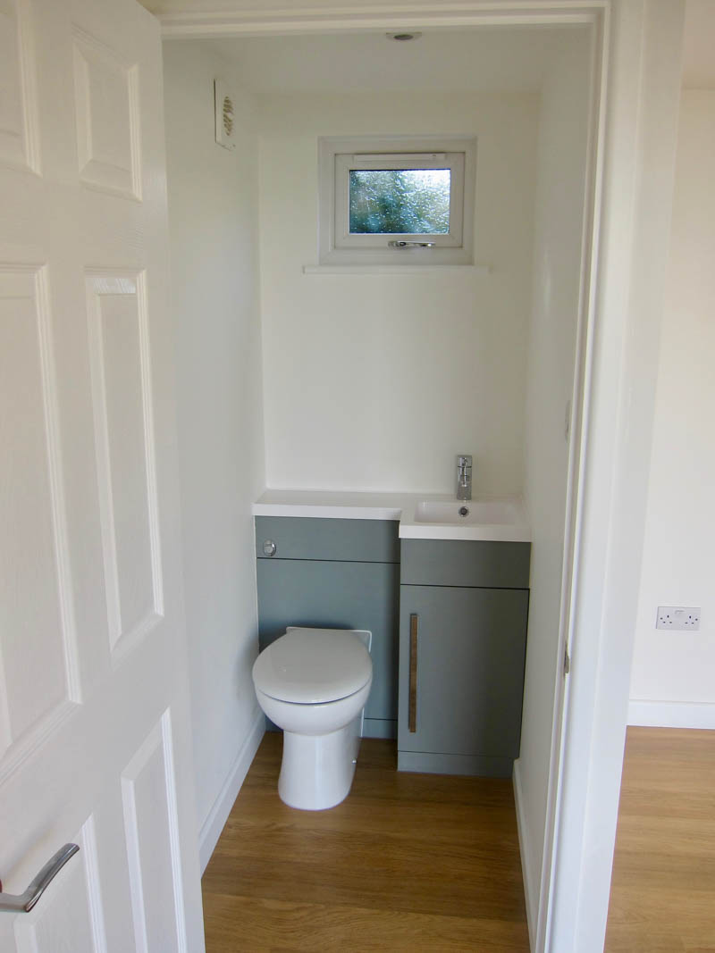 A cloakroom with toilet and space saving vanity unity has been incorporated into the building.