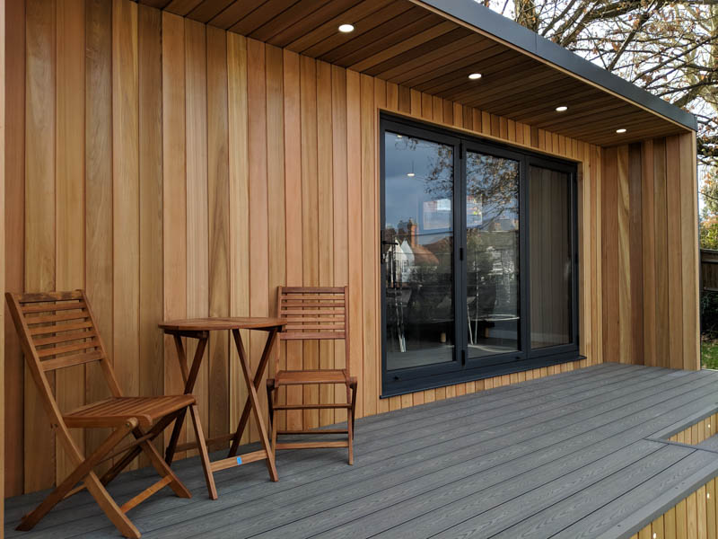 The front wall of the garden room is clad in Cedar