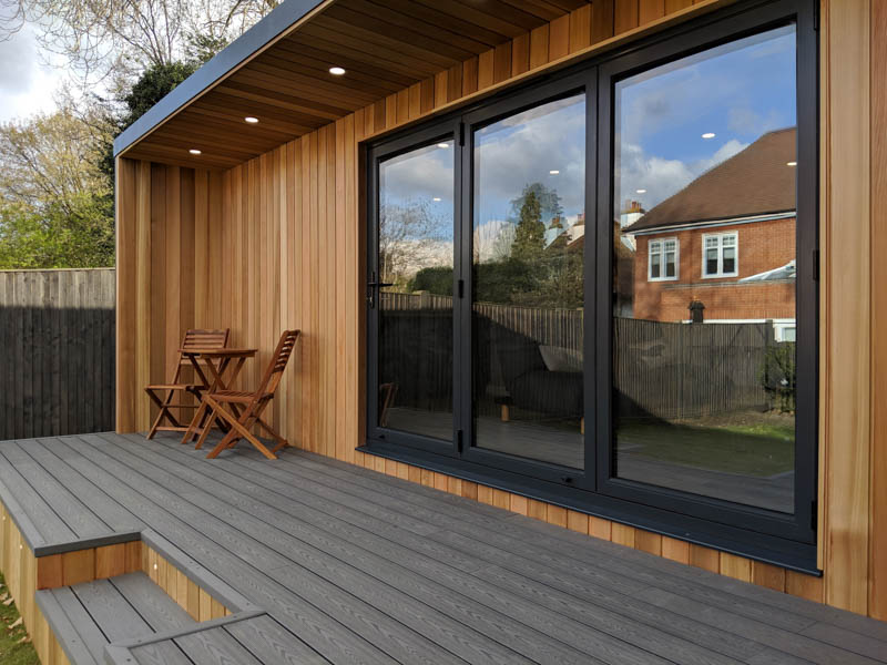A composite deck runs in front of the garden room