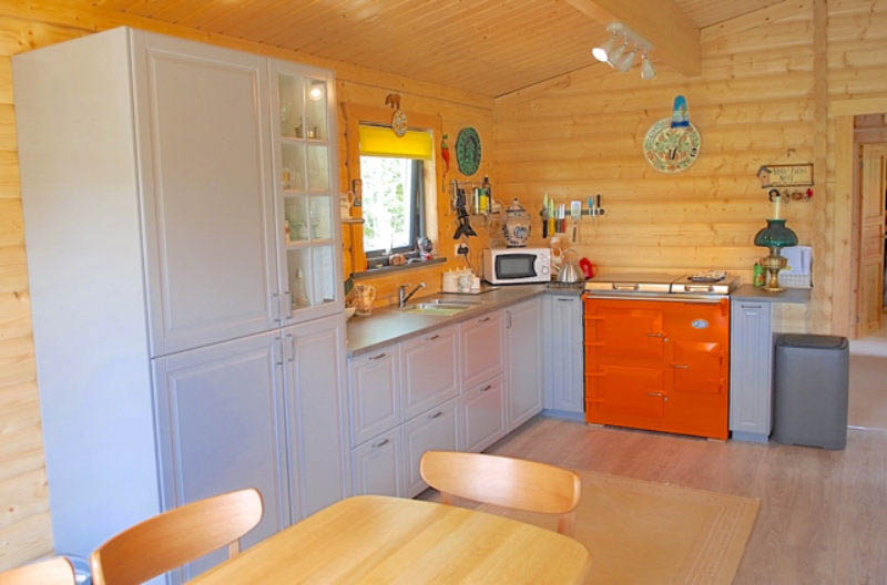A modern, well equipped kitchen has been fitted in the log cabin