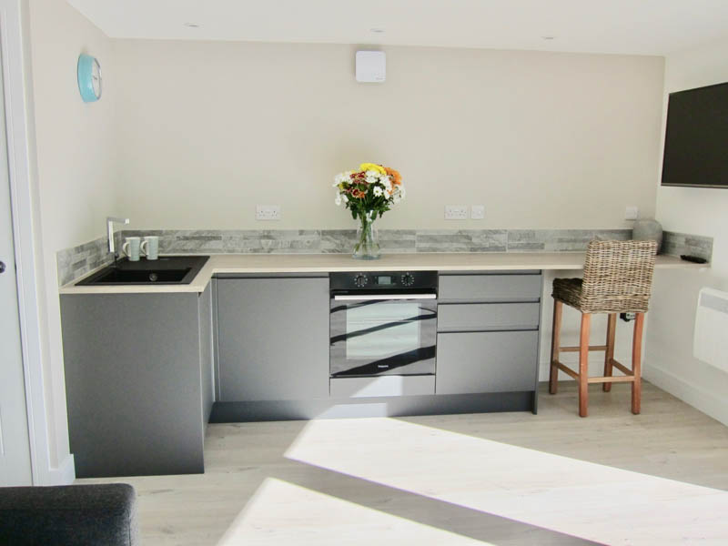 The annexe has a modern kitchen with breakfast bar