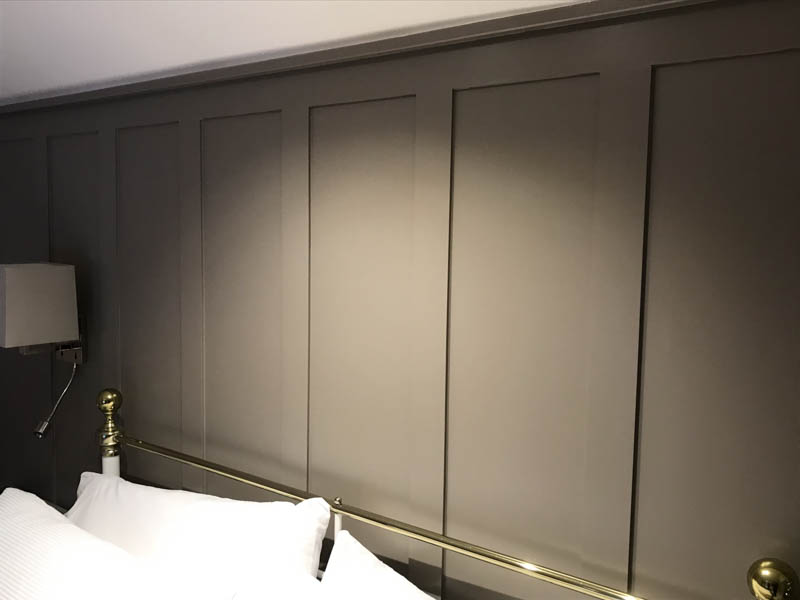Feature panelling behind the bed