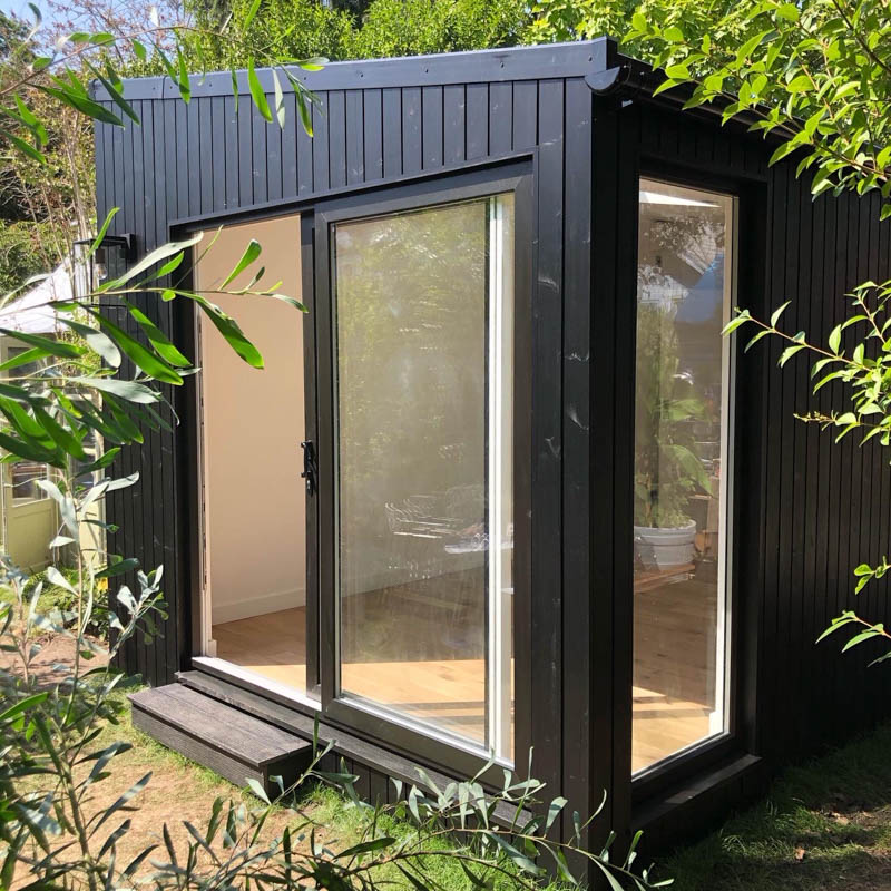 Black clad garden rooms by Ark Design Build