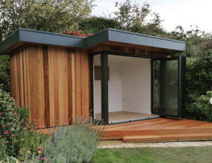 Contemporary L-shaped garden room with secret storage shed by Bridge Garden Rooms