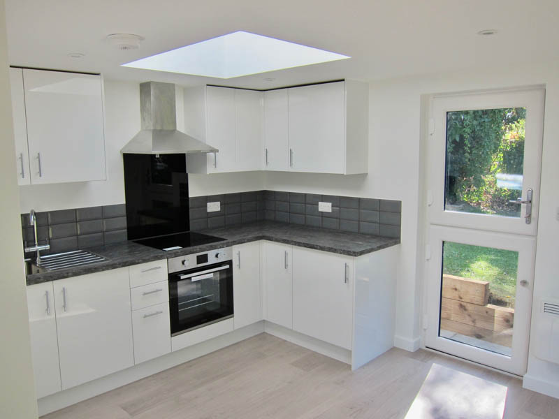 L-shaped kitchen with large Velux roof window