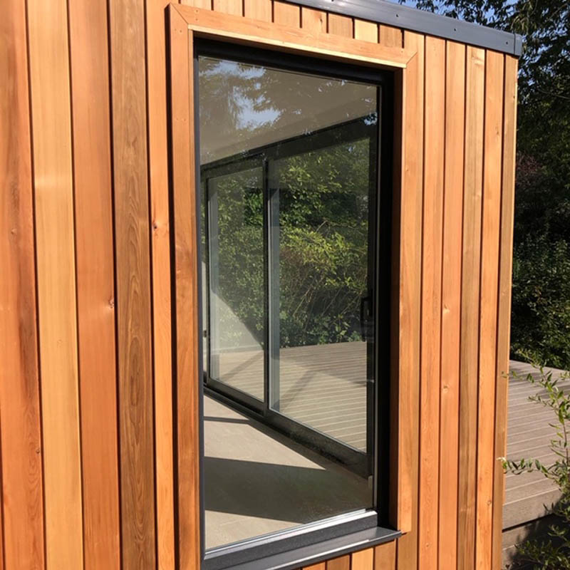 Cedar garden room with hidden shed by Ark Design Build