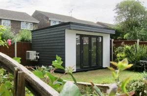 Garden office with grey Cedral and white render walls