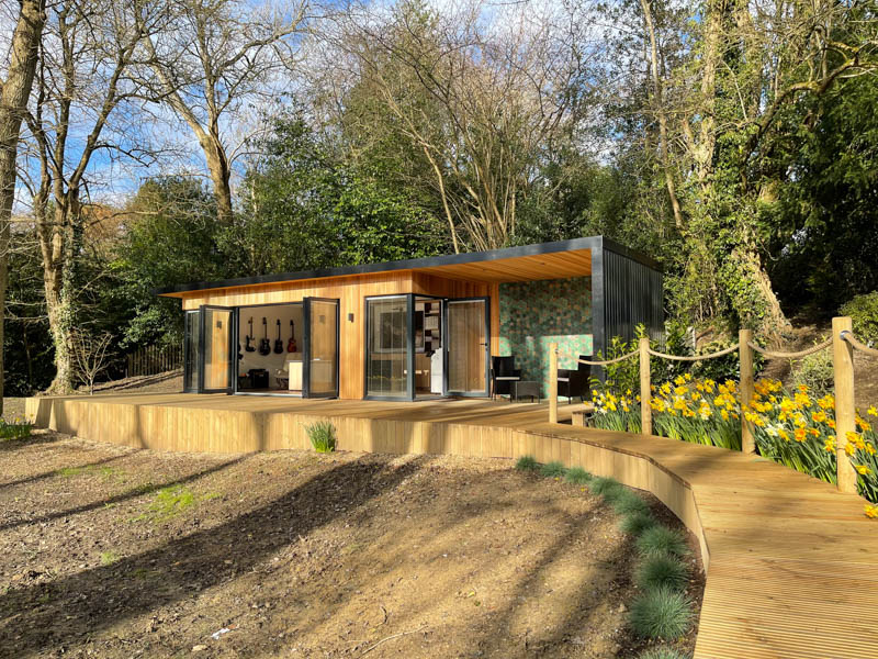 Bespoke garden office with outdoor seating area by A Room In The Garden