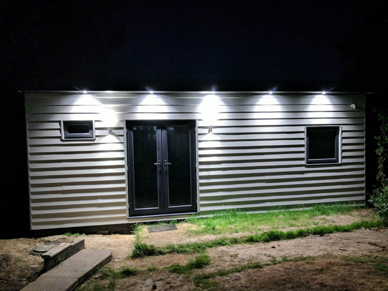 Exterior of the office at night showing the exterior lighting