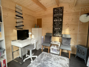 Inside an insulated log cabin office by Hargreaves Garden Spaces
