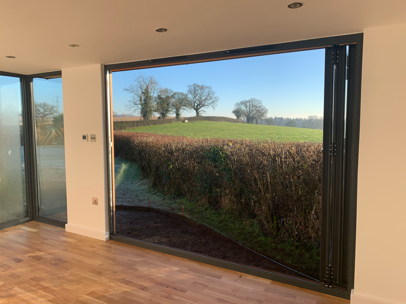Bifold doors open up to allow the countryside views in