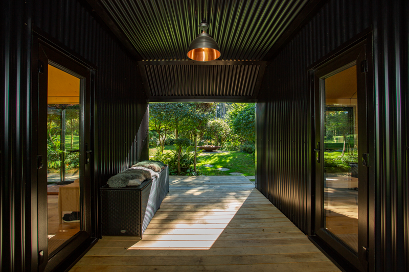 A covered walkway sits between the two rooms