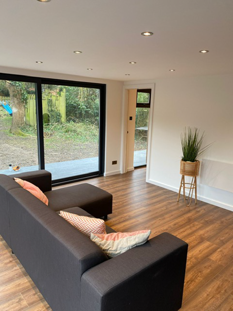 The main living space features large sliding doors on the front elevation