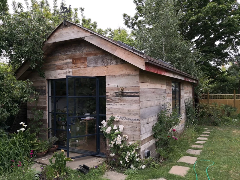 Pitched roof, reclaimed wood garden room by Eleven Trees