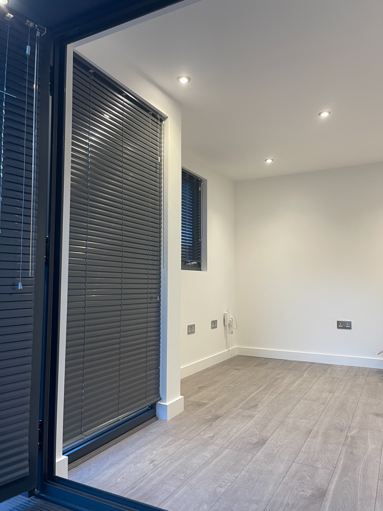 Aluminium Venetian blinds have been fitted at the windows of the garden office