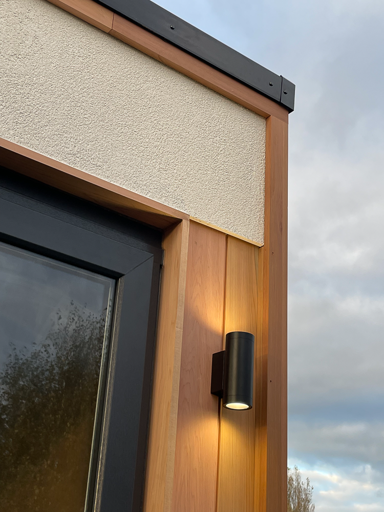 The white render and Cedar cladding have been beautifully detailed