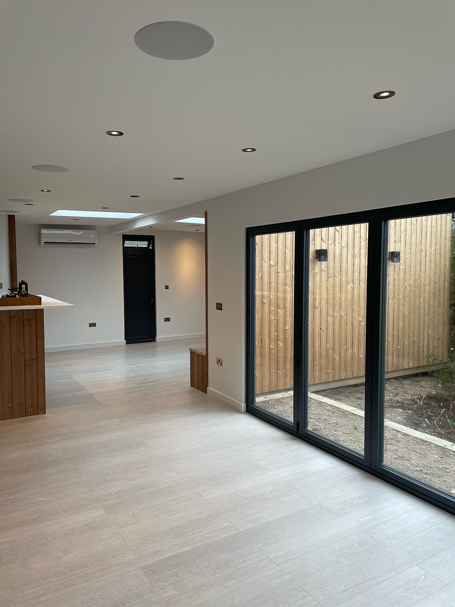 The high ceilings and bi-fold doors create a wonderfully light and airy interior