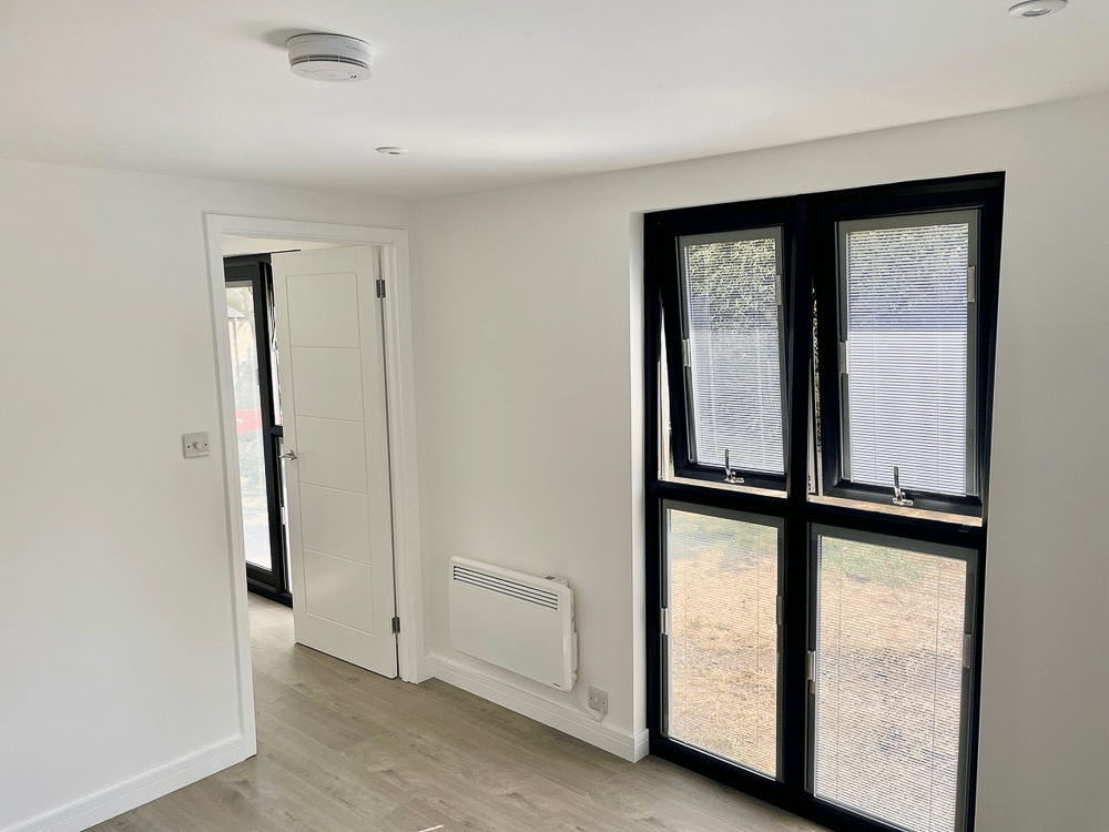 Floor to ceiling glazing in a two room Executive Garden Room designed to replace a garage