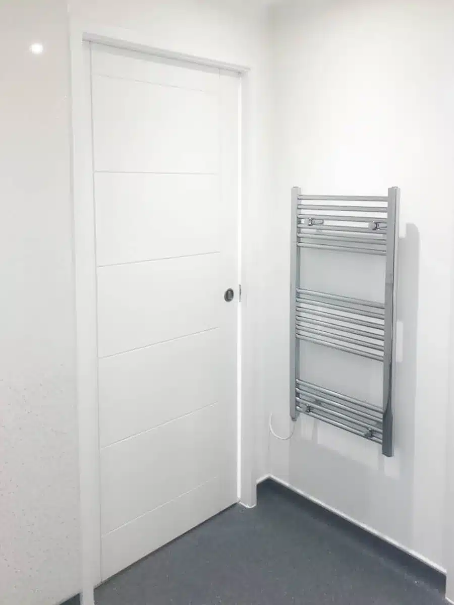 The shower room features pocket doors for easy access