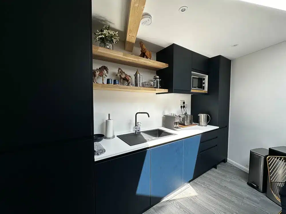 The mobile home annexe features a contemporary navy blue kitchen