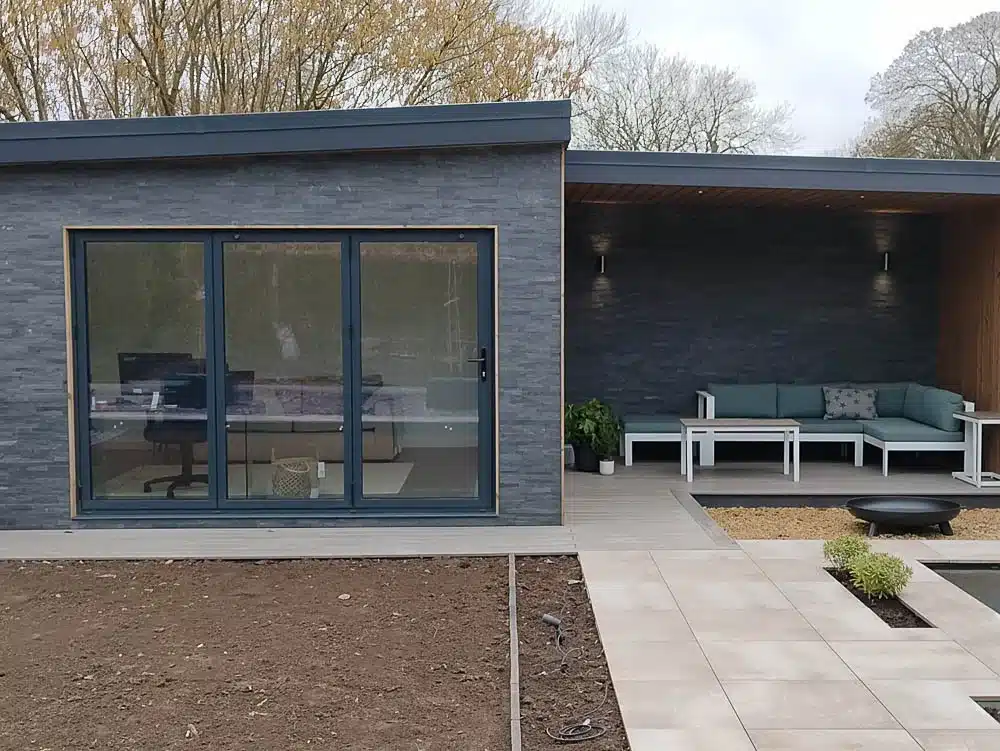 Front view of the slate clad garden office showing the covered seating area