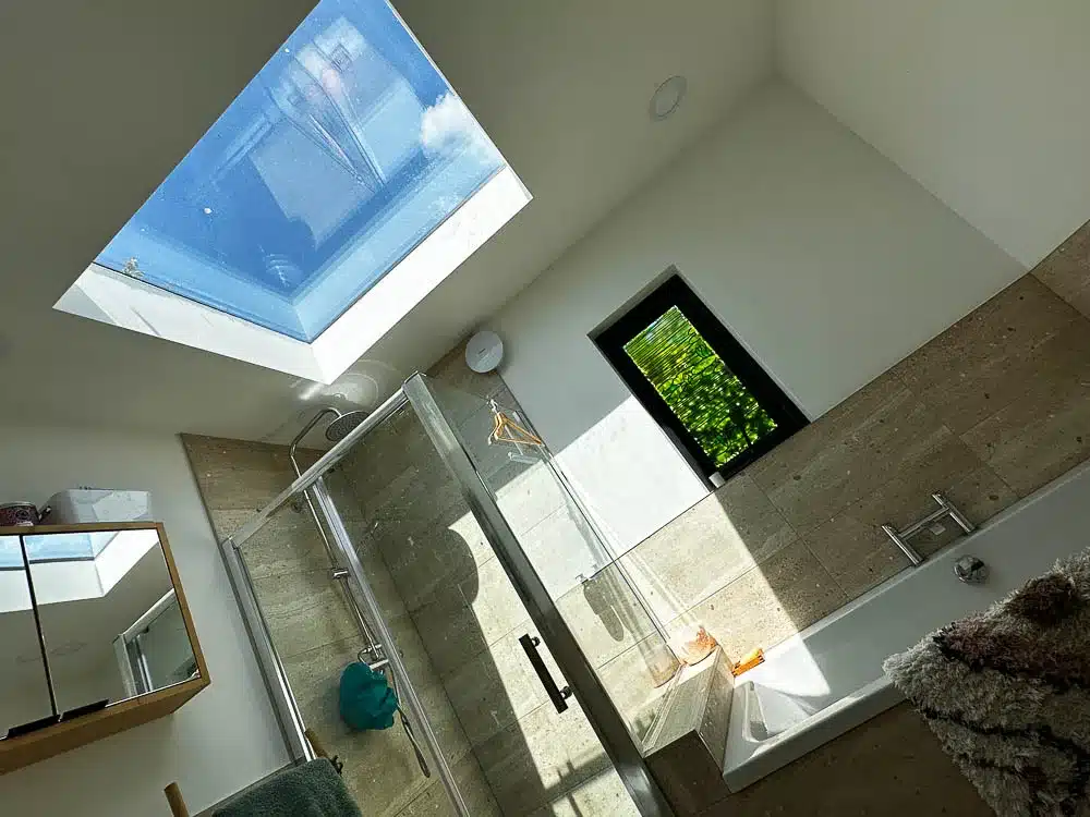 A large skylight floods the bathroom with natural light
