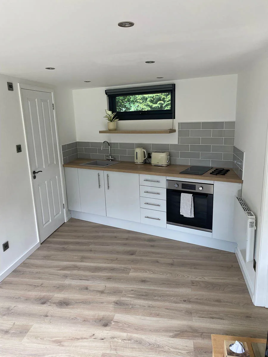 Inside the Ark Design Build annexe with the kitchen fitted on the angled rear wall