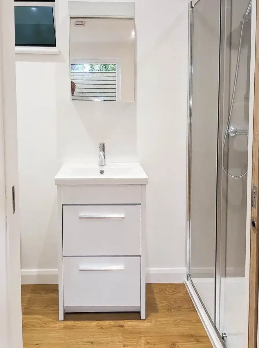 The shower room features a large shower cubical