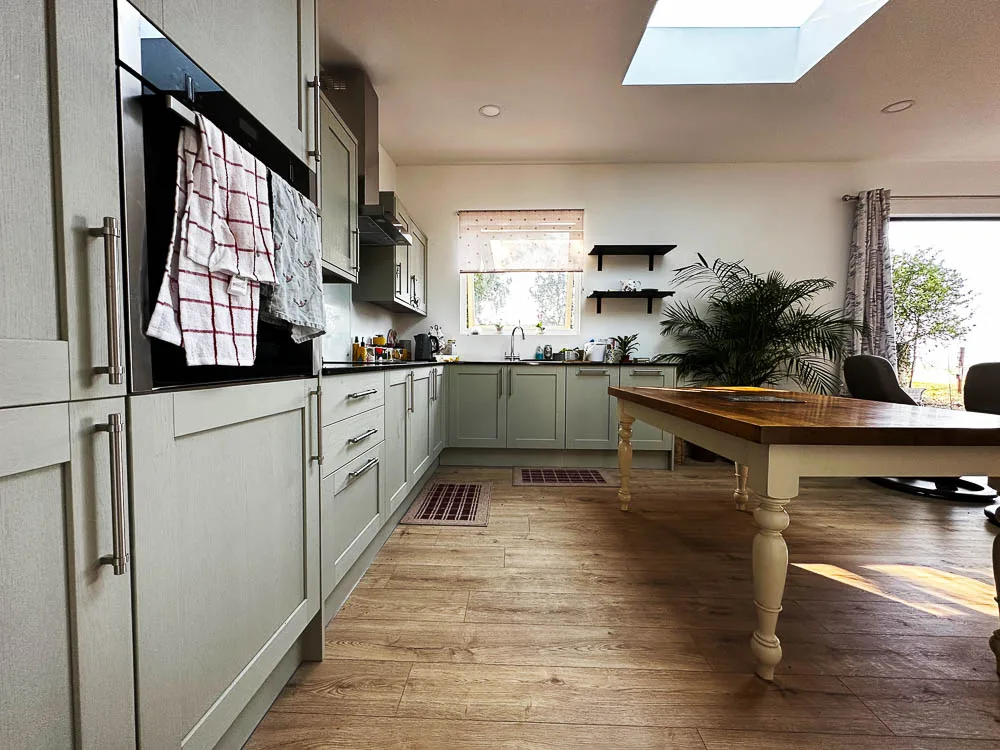 A skylight has been positioned over the traditional farmhouse kitchen table