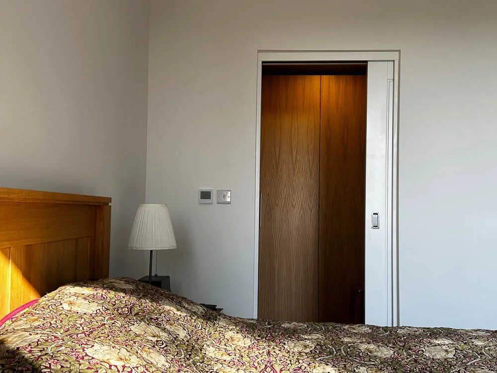 A pocket door leads off the bedroom into the bathroom