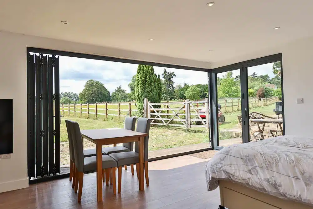 Two sets of bi-fold doors open a corner of the annexe up onto the garden