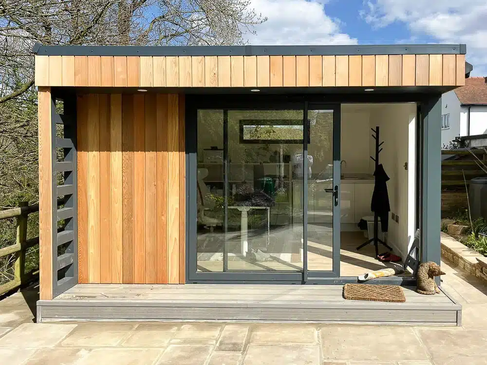 The 4m x 3.5m design includes a covered veranda on the front elevation that features a chunky slatted sun screen