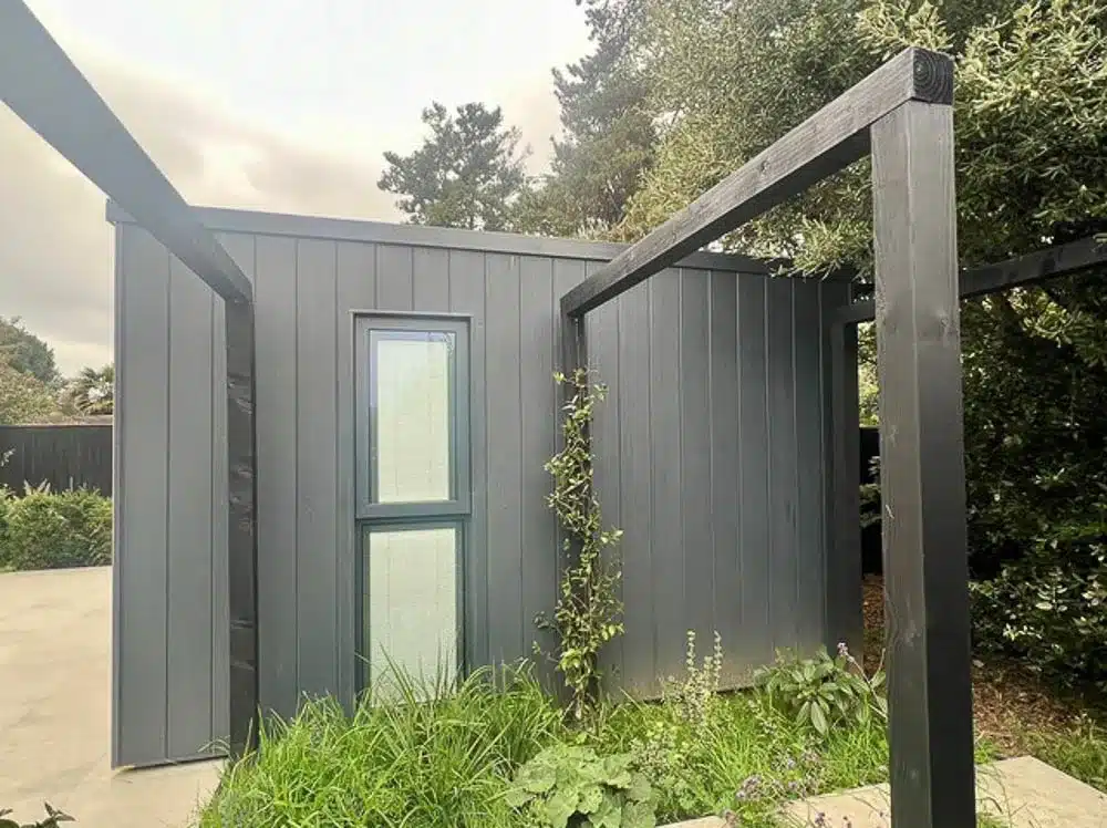 The side wall features dark grey composite cladding fitted vertically