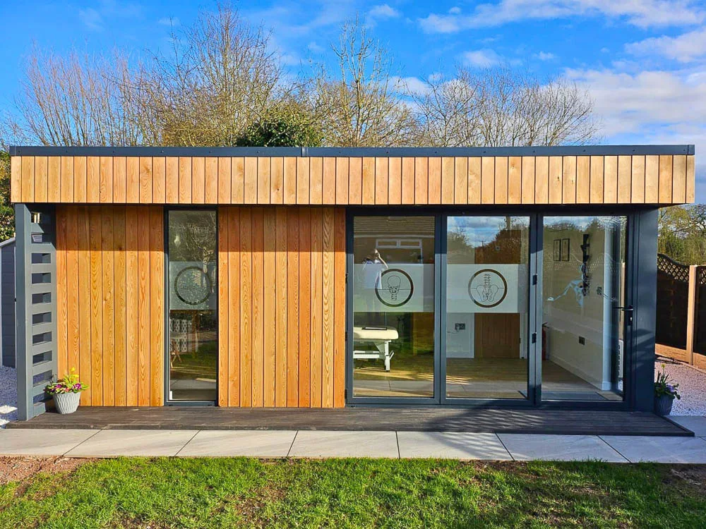 The exterior of the garden room has been clad in Siberian Larch