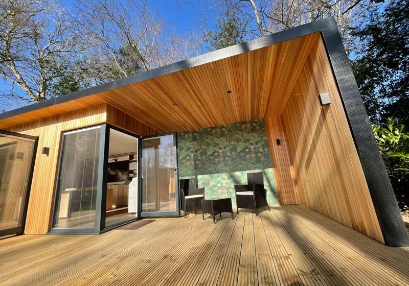 Bespoke garden office with outdoor seating area by A Room In The Garden