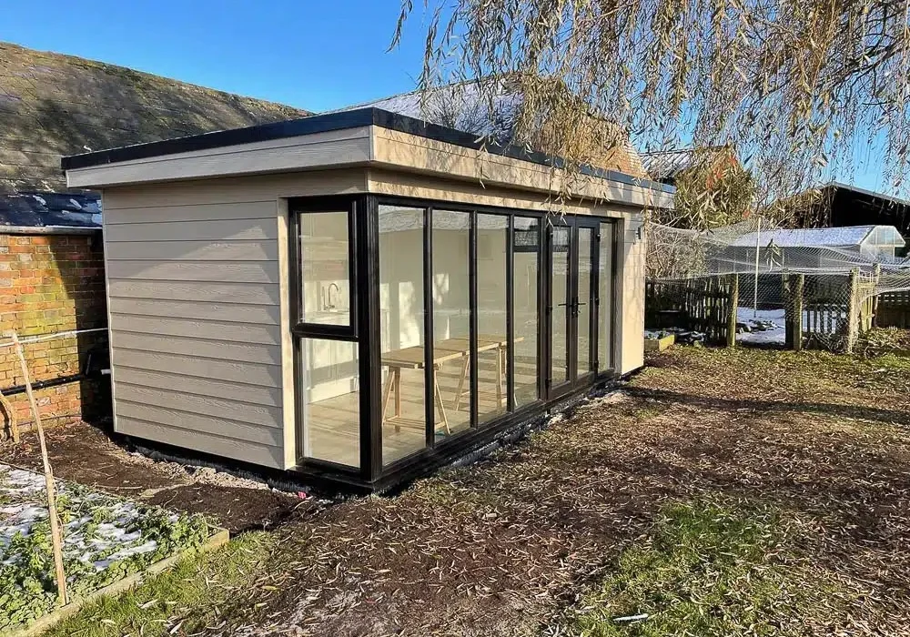 The black doors and windows have been mixed with light brown Cedral cladding